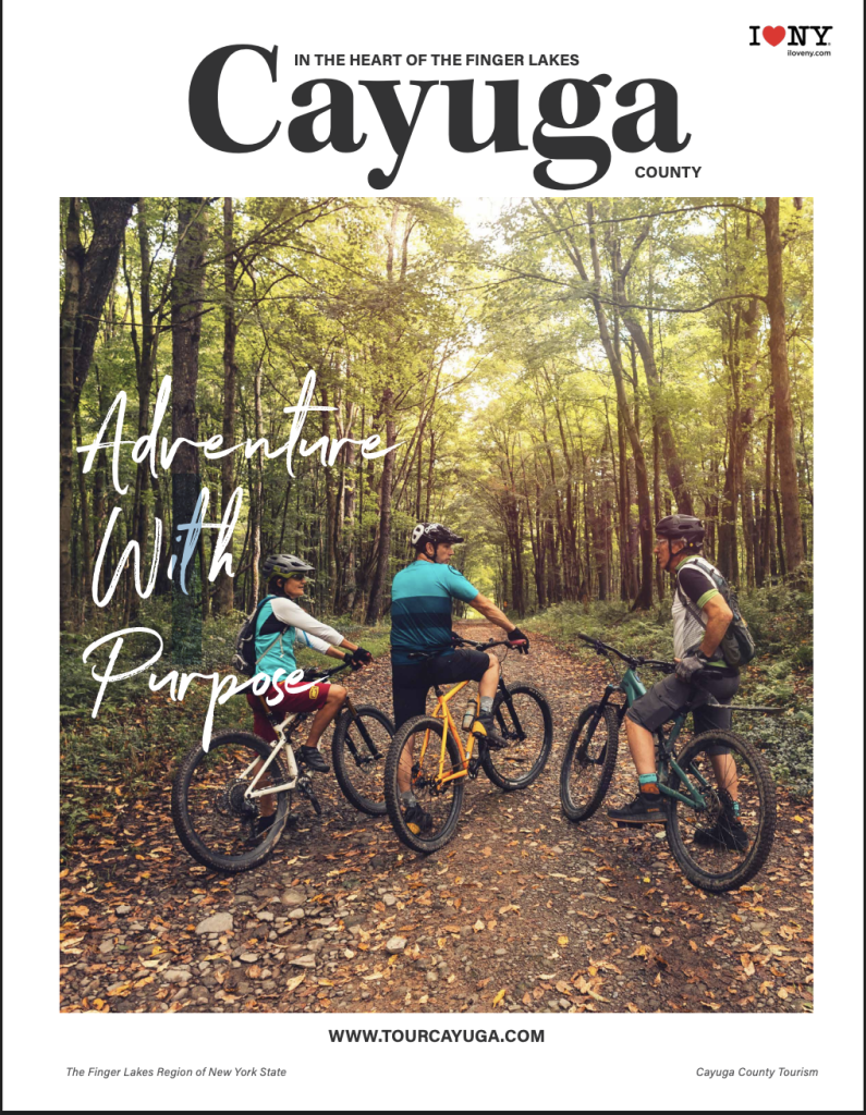 Magazine Cover with a photo of three adults on mountain bikes on a dirt path in the woods during spring